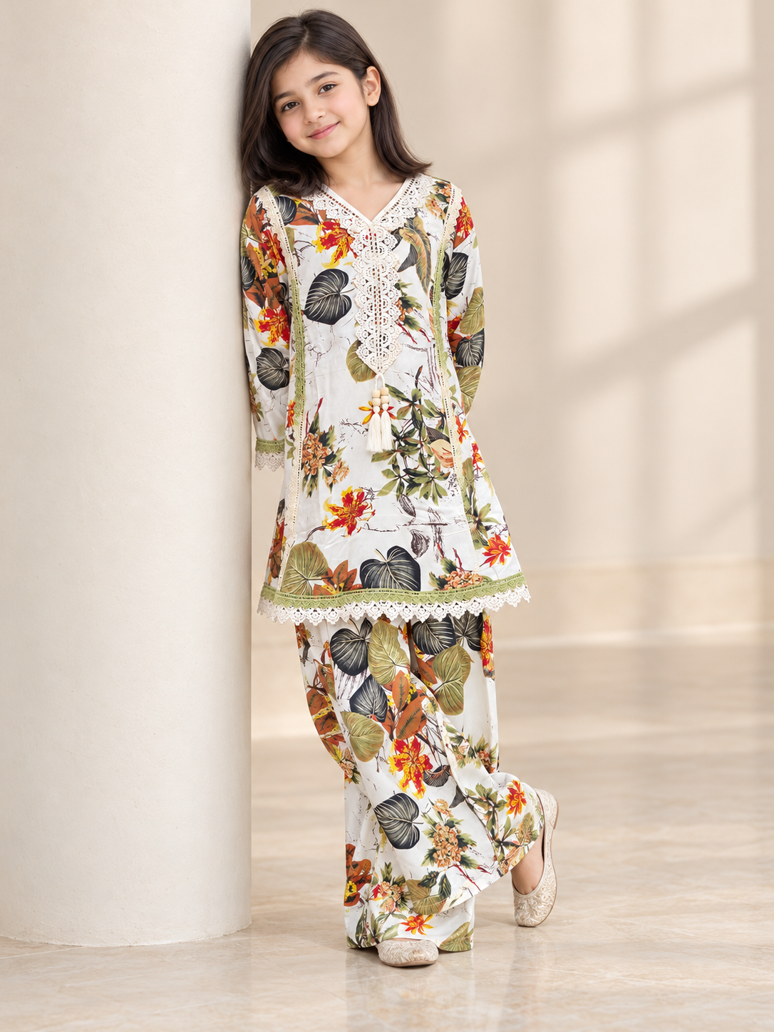 Detail view of the multicolor botanical print, lace trim and tassel accent