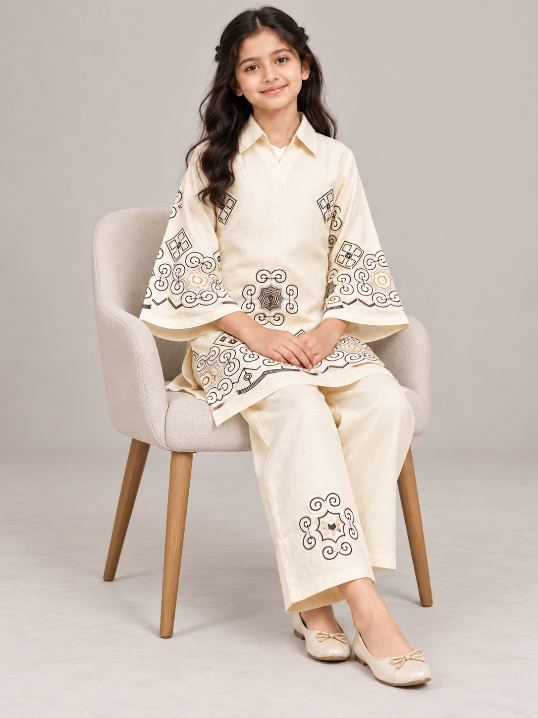 Model wearing the cream cotton embroidery kurti set, seated
