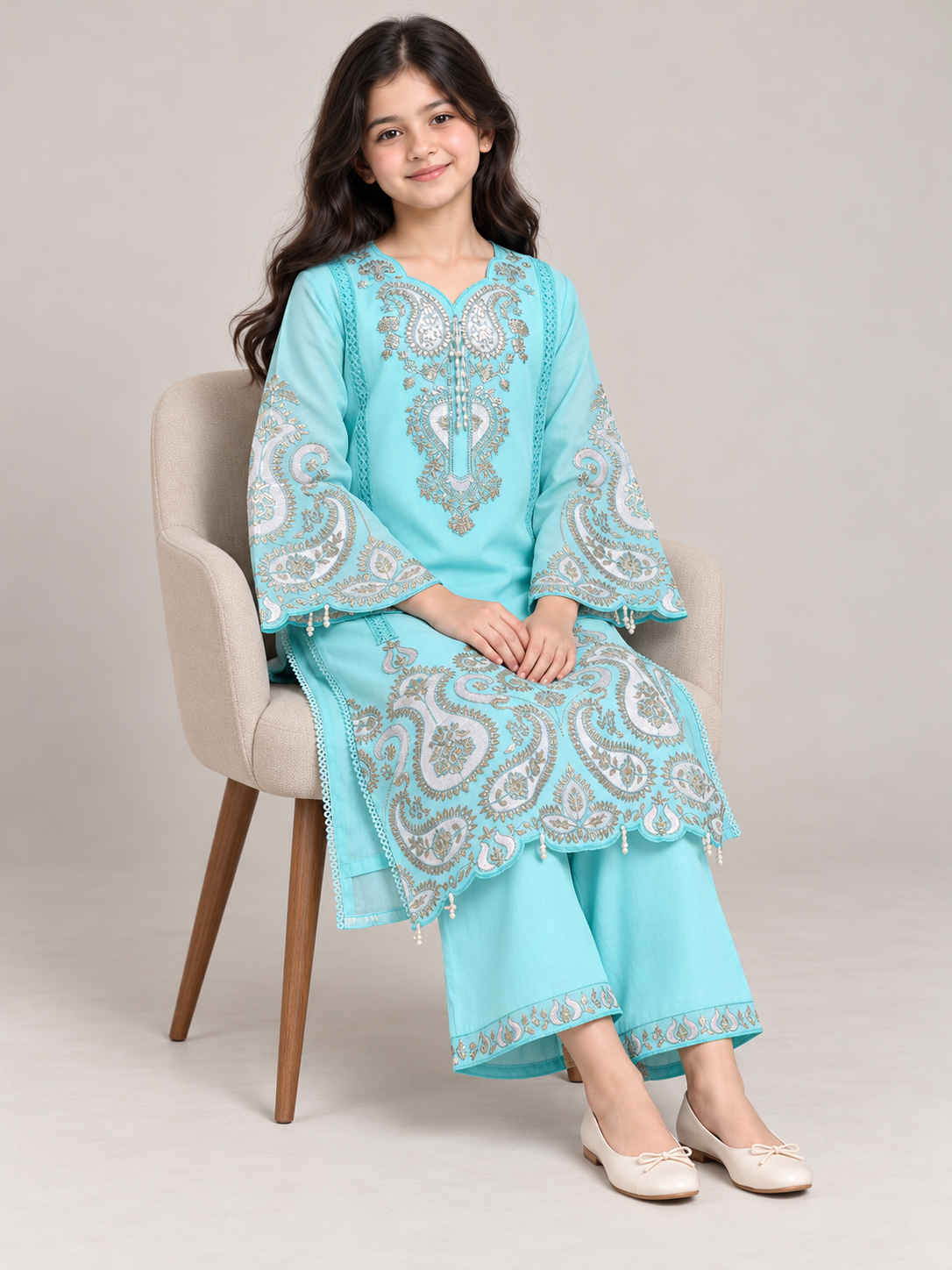 Model wearing the blue cotton embroidery kurti set, seated