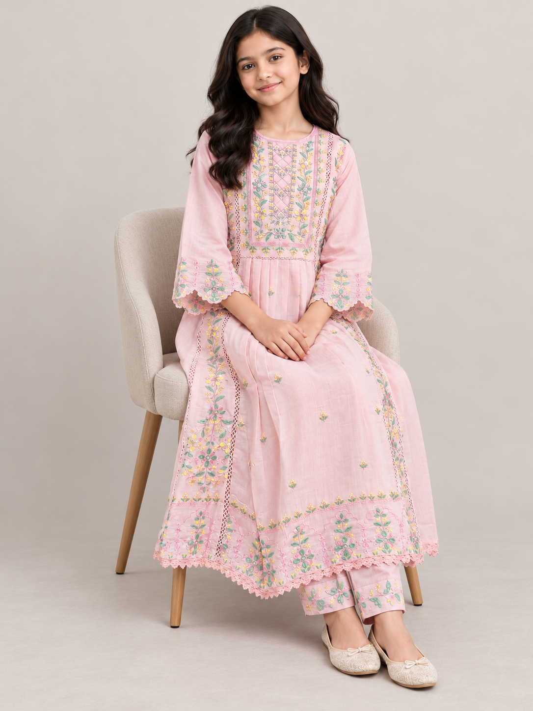 Model wearing the pink cotton embroidery gown set, seated
