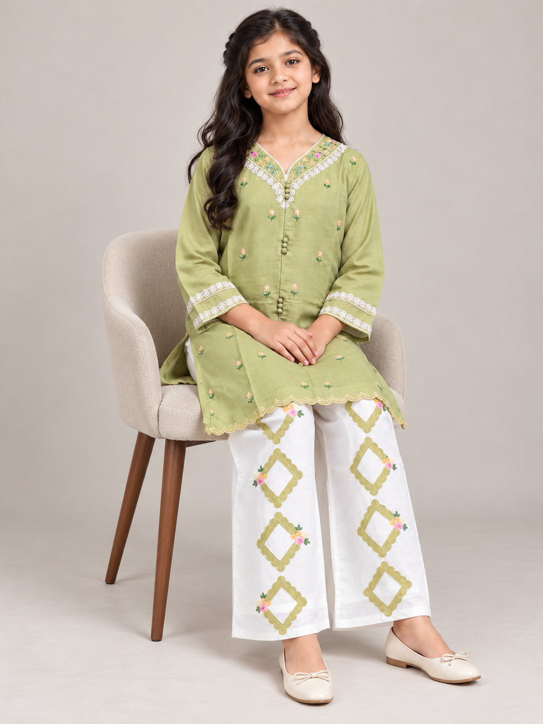 Model wearing the green cotton embroidery kurti set, seated