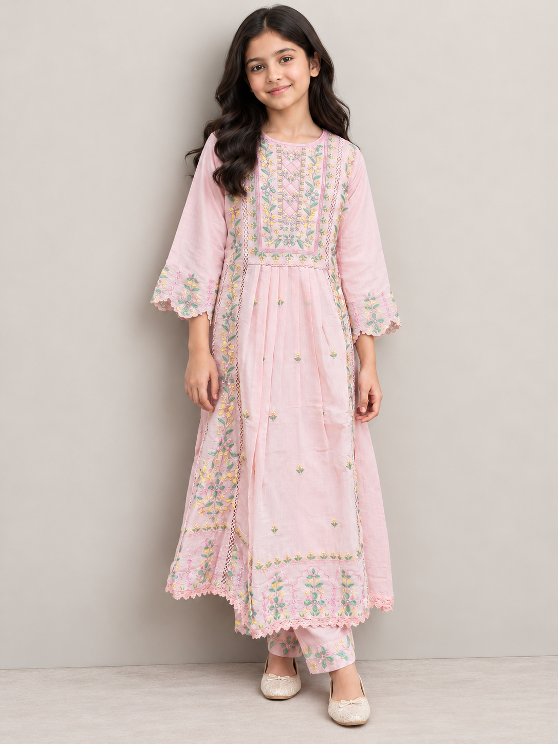 Model wearing the pink cotton embroidery gown set, standing by a wall